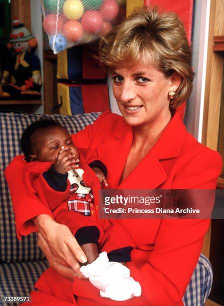 Princess Diana holding eight week old baby Tamara at the London Lighthouse, a centre for people affected by HIV and AIDS, in London, October 1996.