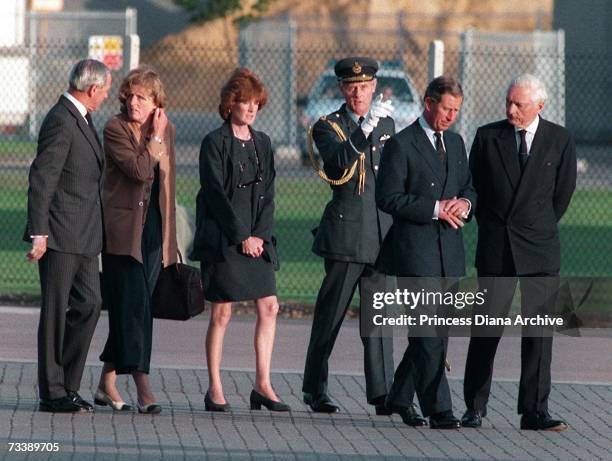 Prince Charles, the Prince of Wales, Lady Jane Fellows and Lady Sarah McCorquodale with officials at RAF Northolt to meet the coffin of their sister,...