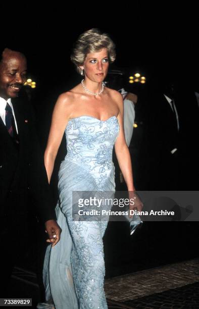 The Princess of Wales arrives at a presidential banquet held in Douala, Cameroon, March 1990. She wears a Catherine Walker dress.