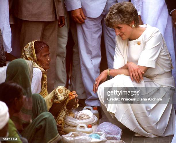 The Princess of Wales talking to a local woman during a visit to Hyderabad, India, February 1992. Diana is wearing a Catherine Walker outfit.