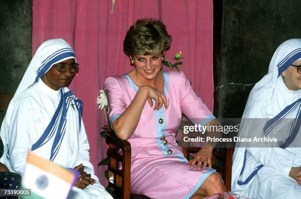 The Princess of Wales with two nuns during a visit to Mother Theresa's headquarters in Calcutta, India, 15th February 1992. Diana is wearing a dress...