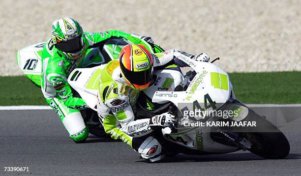 Fonsi Nieto of Spain competes with Roberto Rolfo of Italy competes during the qualifying practice of the World Superbike Championship at the Losail...