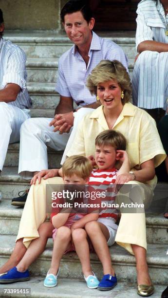 The Prince and Princess of Wales on holiday with their children, Princes William and Harry, at the Spanish royal residence Marivent Palace, August...
