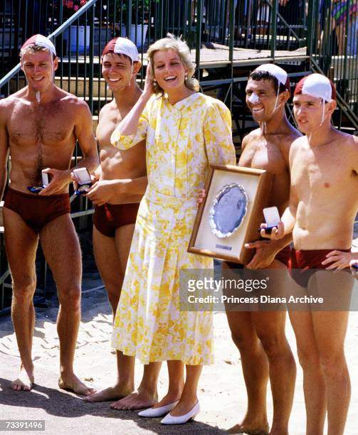 The Princes of Wales meeting lifeguards at Terrigal beach during her visit to Australia, January 1988. She is wearing a Paul Costelloe dress.