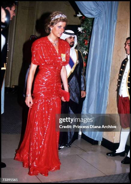 The Princess of Wales, wearing a red gown by Bruce Oldfield, arriving at Claridges in London to attend a banquet held by the ruler of the United Arab...