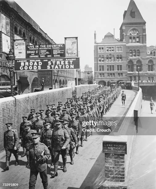 Company of engineers of the Territorial Army leave Liverpool Street Station in London for their annual holiday training camp on Salisbury Plain, 18th...