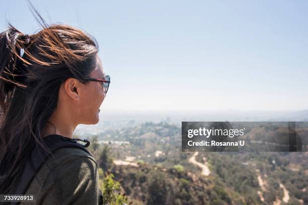 young woman looking out at landscape from hollywood sign, los angeles, california, usa - hollywood hills stock pictures, royalty-free photos & images