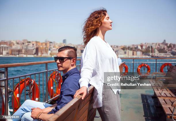 young tourist couple on passenger ferry deck, beyazit, turkey - istanboel europese deel stockfoto's en -beelden