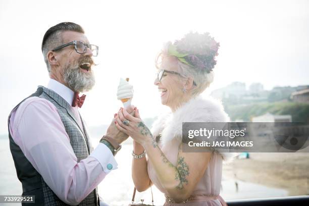 1950s vintage style couple with ice cream cone, laughing on pier - offbeat stock pictures, royalty-free photos & images