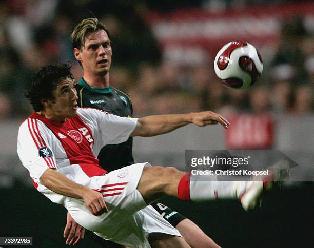 Kenneth Perez of Ajax shoots the ball as Tim Borowski of Bremen looks on during the UEFA Cup round of 32 second leg match between Ajax Amsterdam and...