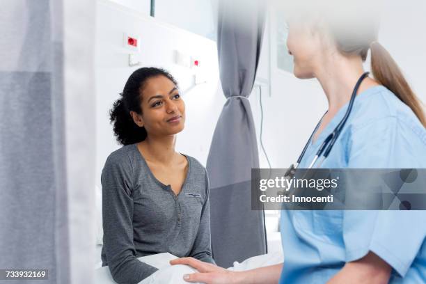 doctor consulting with patient - operating gown stock pictures, royalty-free photos & images