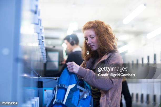 student at locker room in library - school locker room stock pictures, royalty-free photos & images