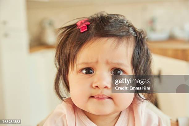 portrait of cute baby girl pulling a face - funny face baby stock pictures, royalty-free photos & images