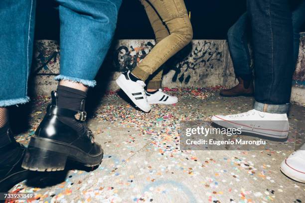 group of friends, standing outdoors, confetti on floor, low section - rooftop party night stock pictures, royalty-free photos & images