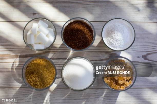glasses of sugar in various forms, overhead view - sugar in glass stock pictures, royalty-free photos & images