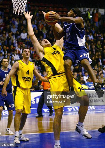 Efes Pilsen's Horace Jenkins tries to basket over Prokom Trefl Sopot's Michael Andersen during their Euroleague Top 16 Group F basketball match at...