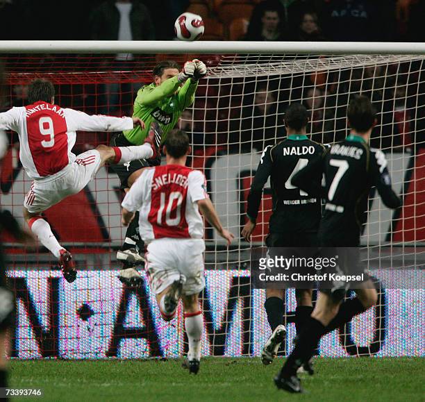 Timm Wiese of Bremen saves the ball against Klaas Jan Huntelaar of Ajax during the UEFA Cup round of 32 second leg match between Ajax Amsterdam and...