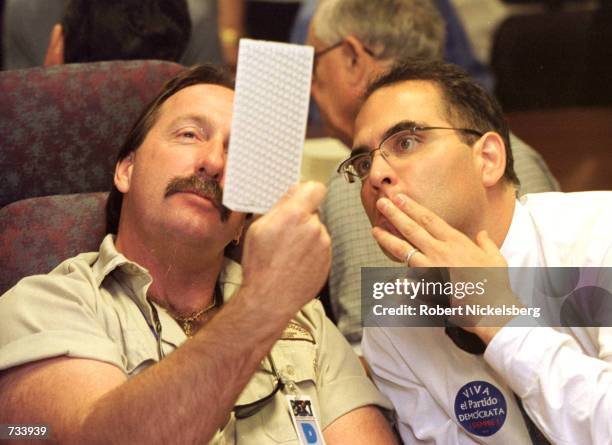 Election board staff and volunteers from both political parties manually recount presidential election votes November 17, 2000 in the Plantation's...