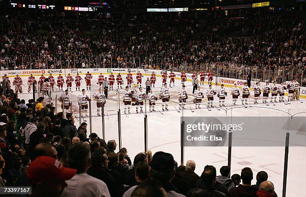 The Boston University Terriers and the Boston College Eagles stand at their respective bluelines prior to the start of the Beanpot Tournament...