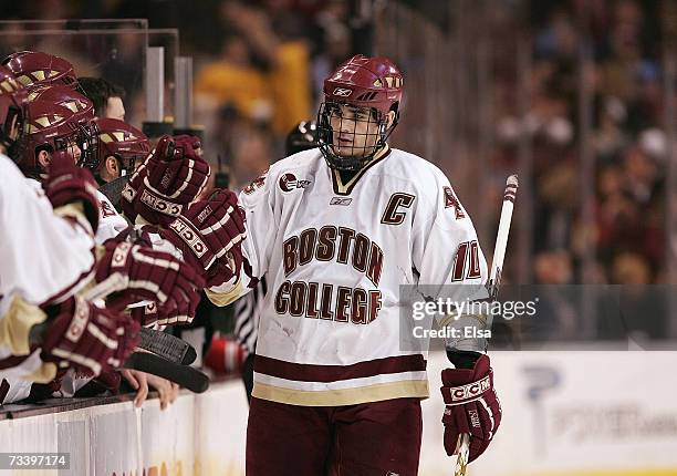 Brian Boyle of the Boston College Eagles skates by the team bench to celebrate with teammates against the Boston University Terriers during the...