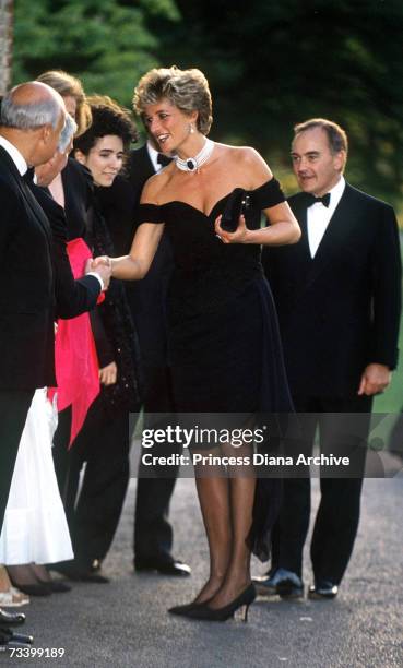 Princess Diana arriving at the Serpentine Gallery, London, in a gown by Christina Stambolian, June 1994. Standing behind her is property developer...