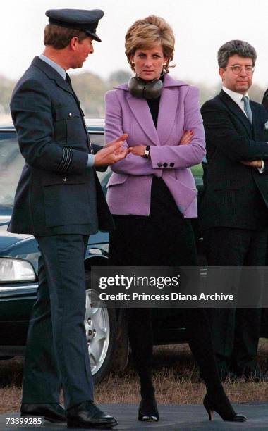 Princess Diana talking to an officer after watching an air display at RAF Wittering, Lincolnshire, September 1995. On the right is Princess' private...