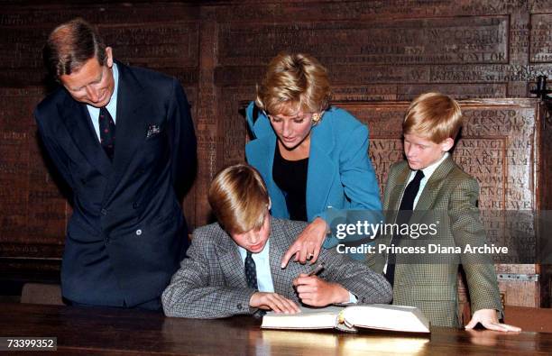 Prince William follows Eton tradition by signing a book before starting at the school, as Prince Charles, Princess Diana and Prince Harry look on,...