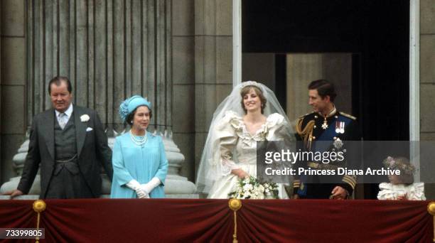 The Prince and Princess of Wales pose on the balcony of Buckingham Palace on their wedding day, 29th July 1981. With them are the Queen and Earl...