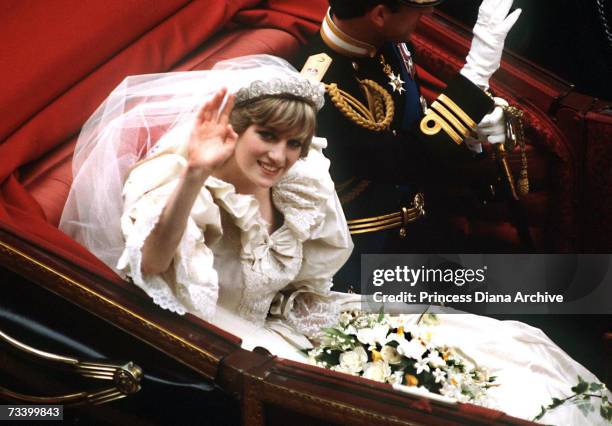 The Prince and Princess of Wales return to Buckingham Palace by carriage after their wedding, 29th July 1981. She wears a wedding dress by David and...