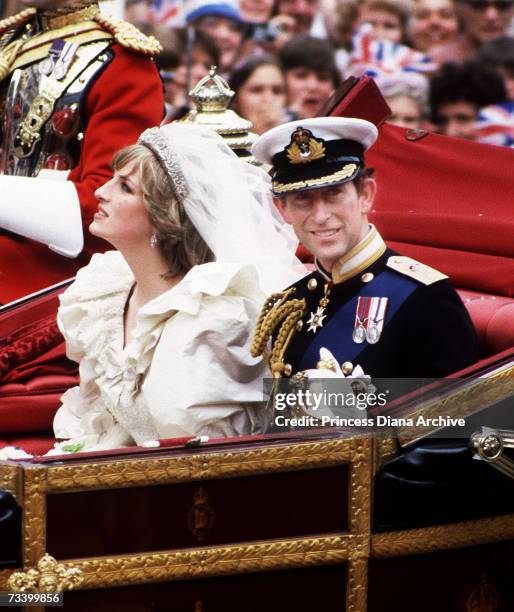 The Prince and Princess of Wales return to Buckingham Palace by carriage after their wedding, 29th July 1981. She wears a wedding dress by David and...