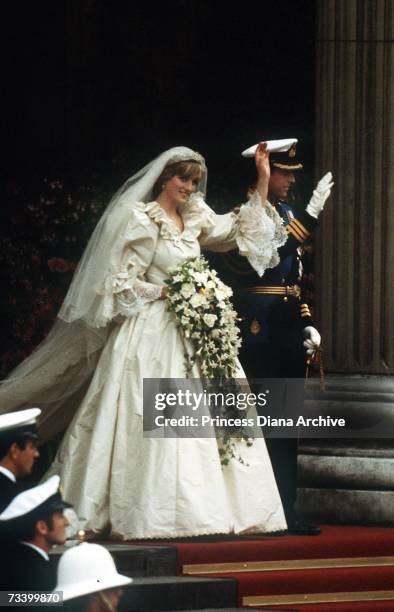 The Prince and Princess of Wales leave St Paul's Cathedral after their wedding, 29th July 1981. She wears a wedding dress by David and Elizabeth...