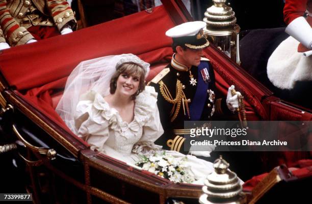 The Prince and Princess of Wales return to Buckingham Palace by carriage after their wedding, 29th July 1981. Diana wears a wedding dress by David...