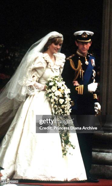 The Prince and Princess of Wales leave St Paul's Cathedral after their wedding, 29th July 1981. She wears a wedding dress by David and Elizabeth...