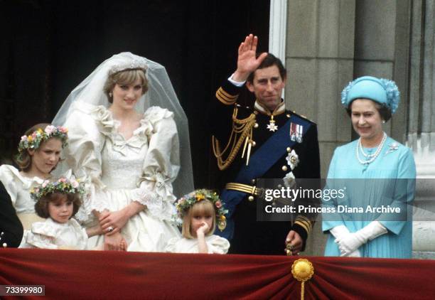 The Prince and Princess of Wales pose on the balcony of Buckingham Palace on their wedding day, with the Queen and some of the bridesmaids, 29th July...