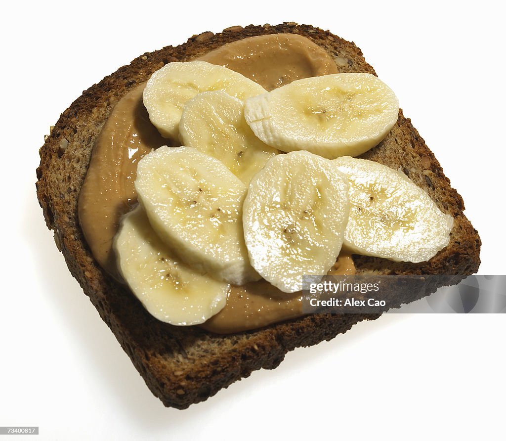 Sliced banana and peanut butter on slice of grain toast