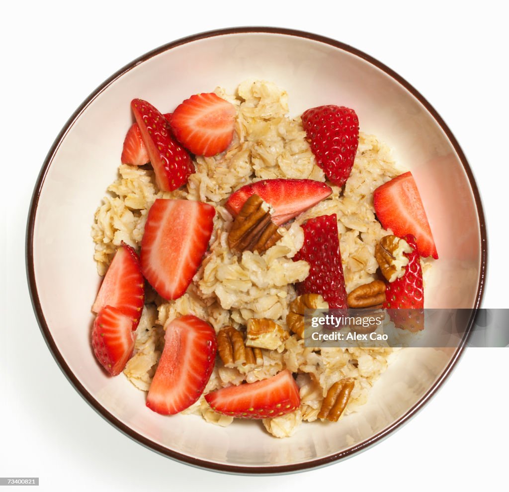 Oatmeal with strawberries and pecans in bowl