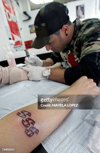 The Costa Rican leader of the Growing in Grace International Ministry Edgar Cancel shows his SSS tatoo -which stands for the sect's motto Salvo...
