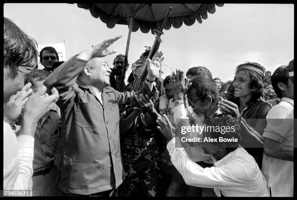 Prince Norodom Sihanouk of Cambodia greets supporters at the Khao-I-Dang refugee camp on the Thai-Cambodian border, 12th July 1982. After returning...