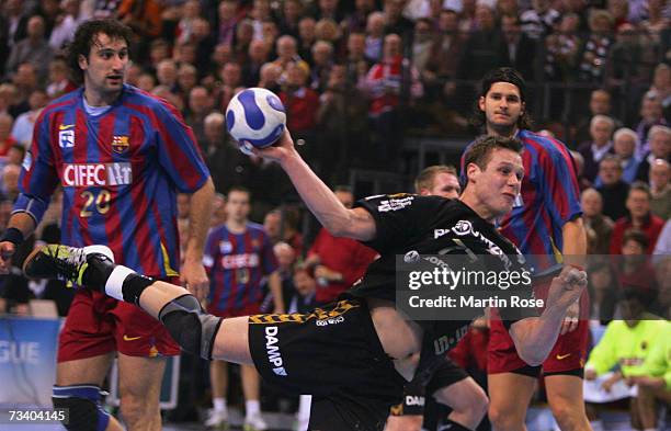Michael Knudsen of Flensburg throws at goal during the Champions League quarter final game between SG Flensburg Handewitt and FC Barcelona at the...