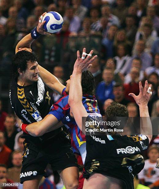 Marcin Lijewski of Flensburg is attacked by Laszlo Nagy of Barcelona during the Champions League quarter final game between SG Flensburg Handewitt...