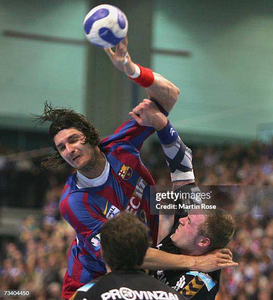 Laszlo Nagy of Barcelona tries to score over Joachim Boldsen of Flensburg during the Champions League quarter final game between SG Flensburg...