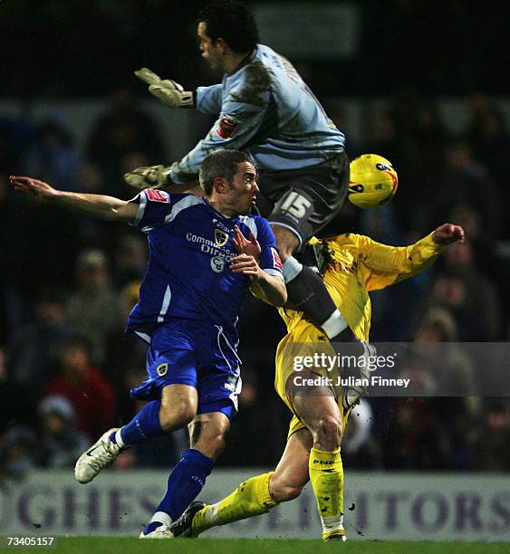 Goalkeeper, David Forde and Kevin McNaughton of Cardiff challenge David Nugent of Preston during the Coca-Cola Championship match between Cardiff...