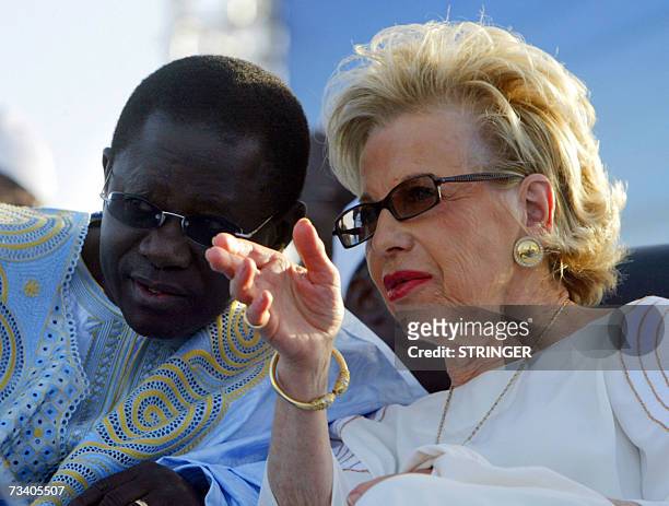 Outgoing president Abdoulaye Wade's Viviane Wade talks with Dakar Mayor Pape Diop, 23 February 2007 in Dakar at a final rally. Campaigning for the 25...