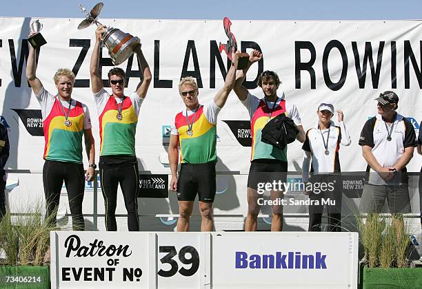 Dane Boswell, Paul Gerritsen, Selwyn Cleland, Eric Murray and cox Rachel Goudie celebrate on the podium with their trophies after winning the Mens...