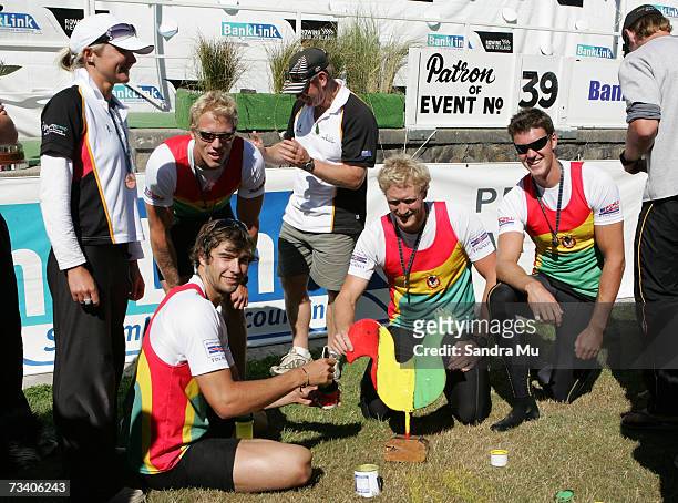 Dane Boswell of Waikato holds the rooster after painting it with Waikato colours as team mates Paul Gerritsen, Selwyn Cleland, Eric Murray and cox...