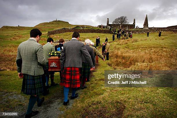 Family members and friends carry the coffin of Chief of Clan MacLeod, John MacLeod into the burial ground at the old ruined church at Kilmuir,...