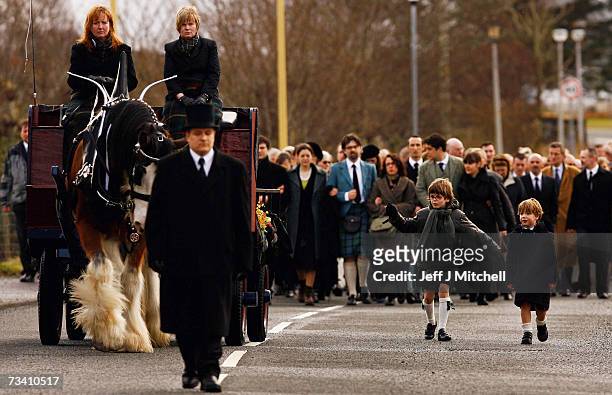 Family members and friends walk behind the coffin of Chief of Clan MacLeod, John MacLeod on the way to the burial ground at the old ruined church at...