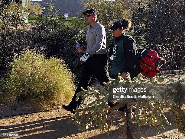 Henrik Stenson of Sweden walks with his caddie Fanny Sunesson on the second hole during the fourth round of the WGC-Accenture Match Play...