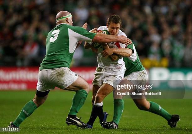 Jonny Wilkinson of England is tackled by John Hayes of Ireland during the RBS Six Nations Championship match between Ireland and England at Croke...