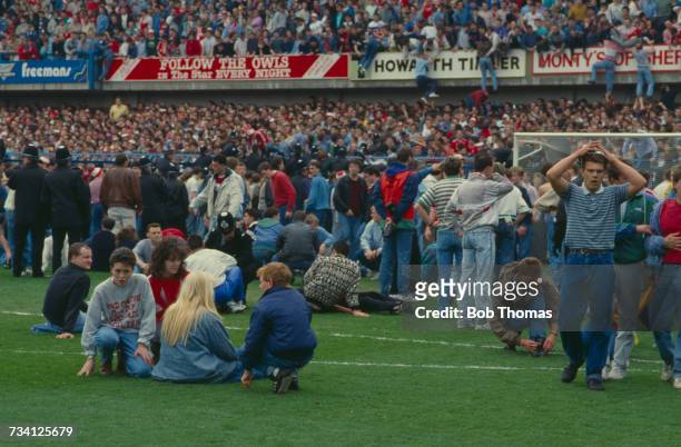 Fans on the pitch at Hillsborough football stadium in Sheffield, after a human crush at an FA Cup semi-final game between Liverpool and Nottingham...